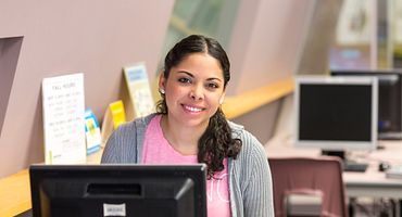 Student writing an article for Centennial Writes